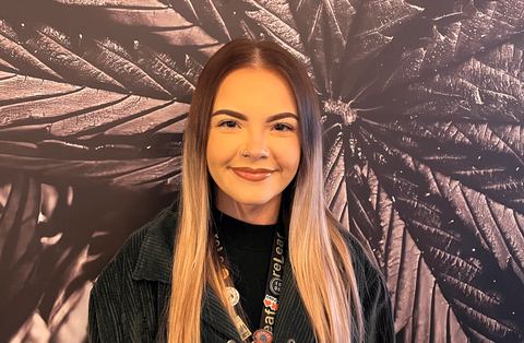 Emma Legere in front of the reLeaf leaf mural
