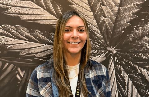Giavanna Fratus in front of the reLeaf leaf mural