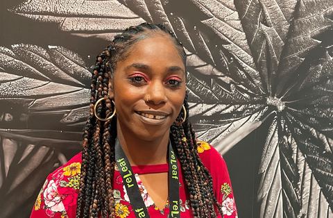 Khadijah Cotton in front of the reLeaf leaf mural