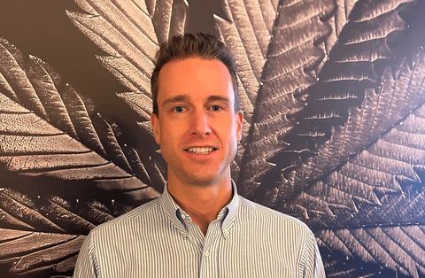 Luke Hunsberger in front of the reLeaf leaf mural
